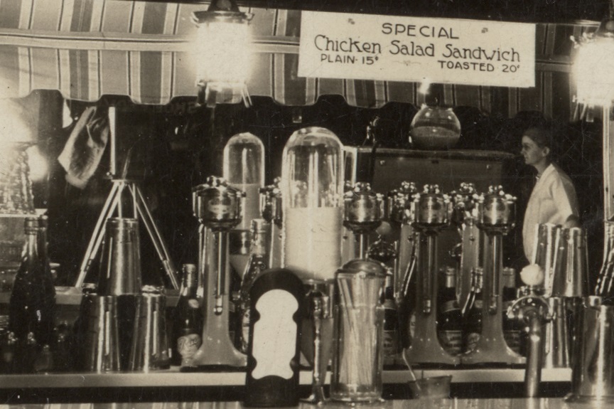 A. J. Anderson's camera (left) reflected in the Crest Confectionery mirror, circa 1928